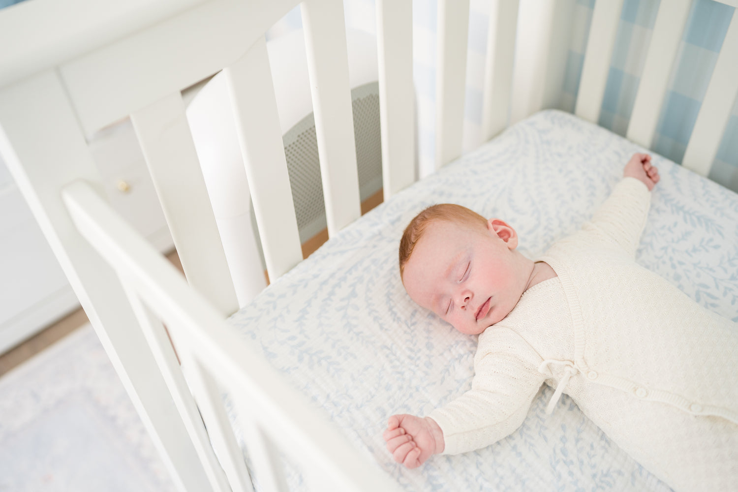 Peacefully Sleeping Baby in Crib with Sereniby Air Purifier in Nursery - Ensuring Clean and Safe Air Quality for Infants